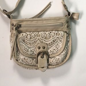 Tan leather and lace crossbody bag.